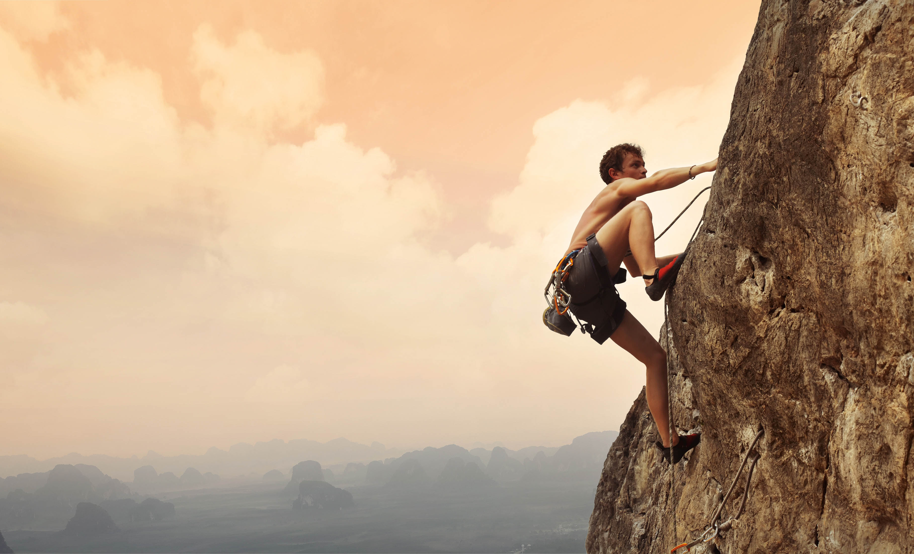 Man climbing a rock face Man climbing a rock face